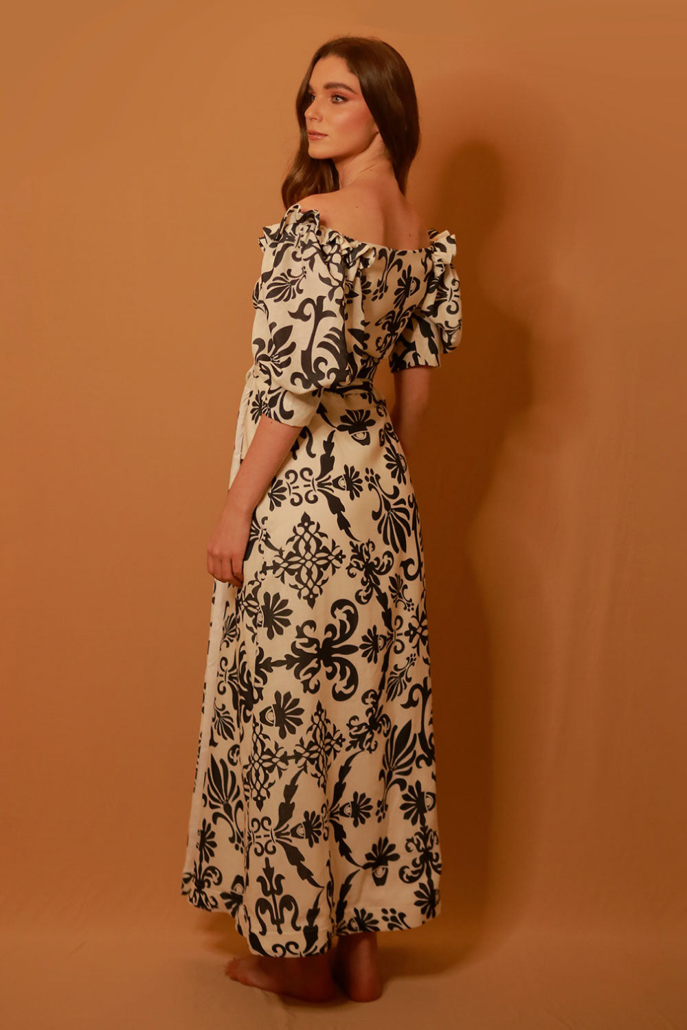 Image of the back of Liliana Meza's Kailani Dress on a model.