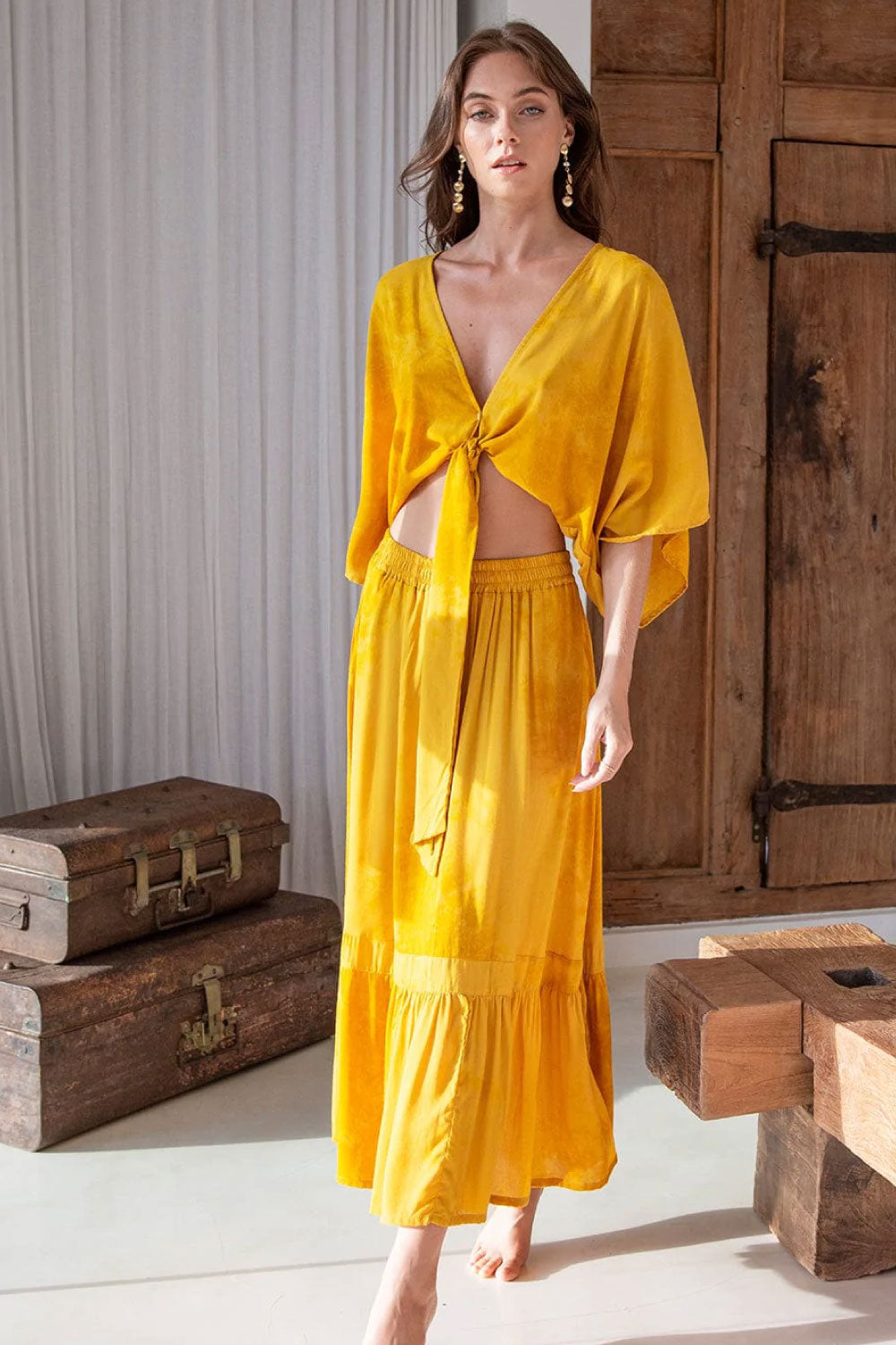 Image of the front of Khush Clothing's Sakura Midi Two-Piece Set, in Slosh Mustard, on a model.