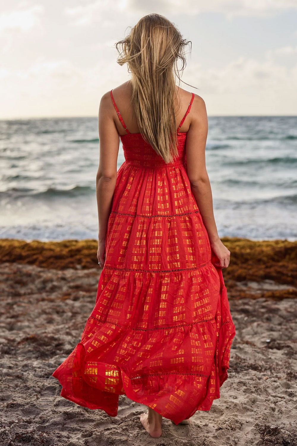 Image of the back of Ranee's Sexy Holiday Dress, in Coral Red, on a model.