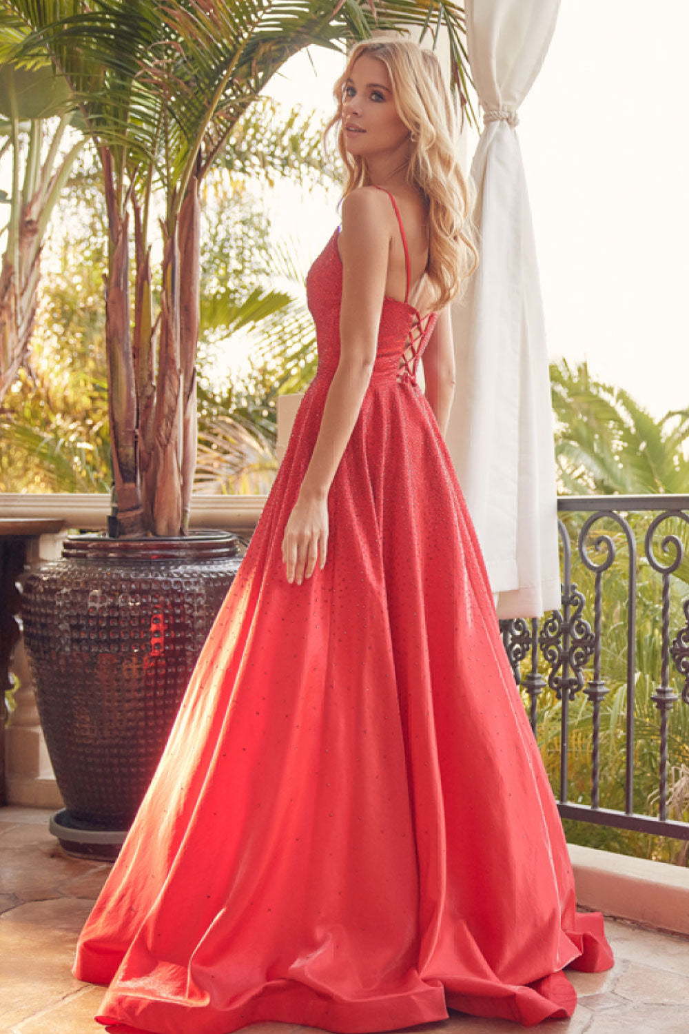 Image of the back of Juliet's Long Sparkly Gown in Red on a model.