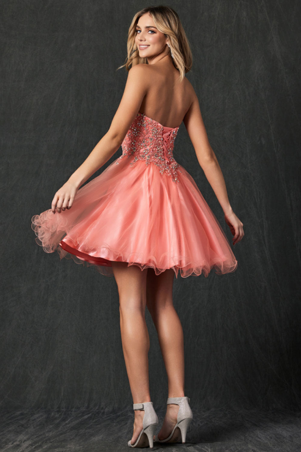 Image of the back of Juliet's Flirty Strapless Prom Dress on a model.