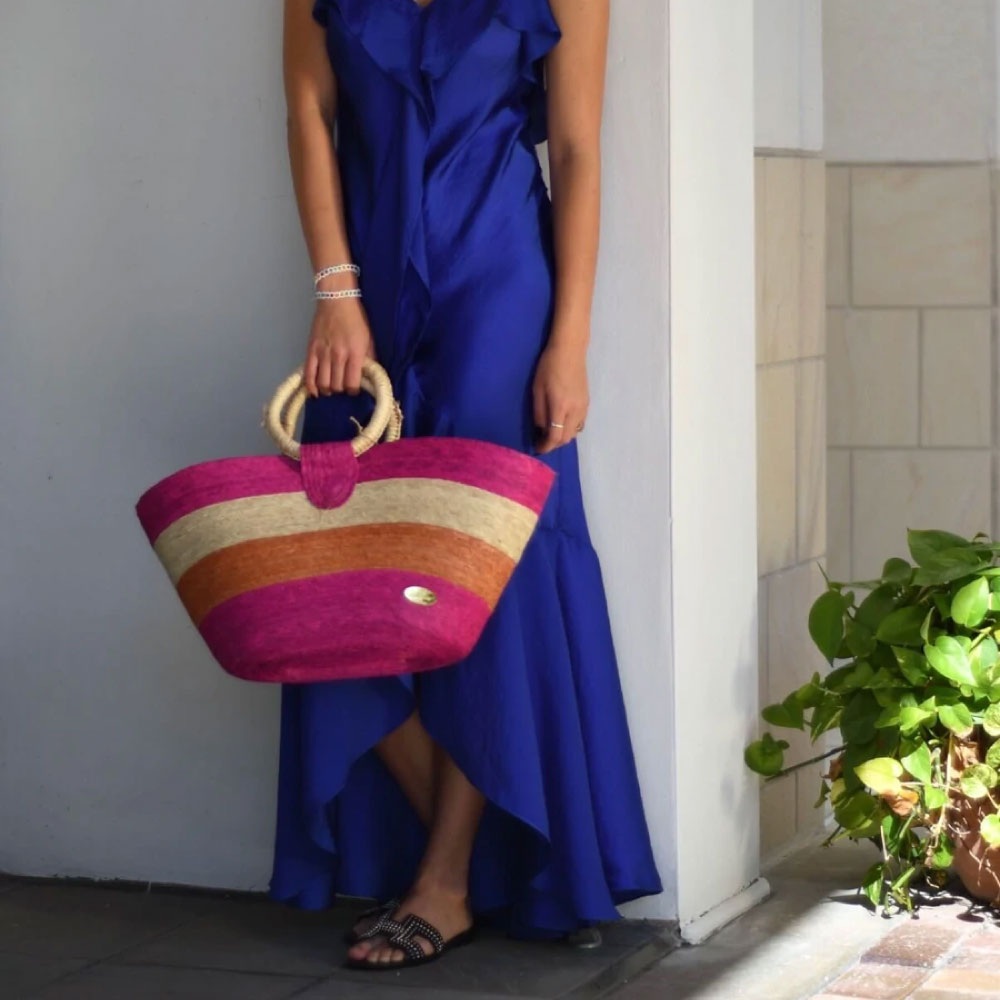 Image of woman holding Alma Straw Bucket Bag in Multi.