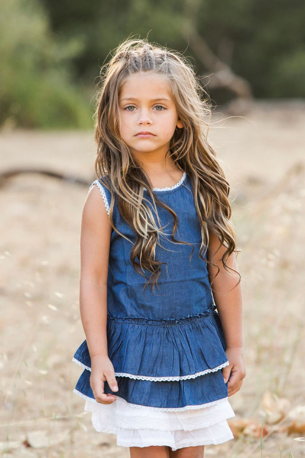 Image of a child wearing the Clementina Denim Dress.