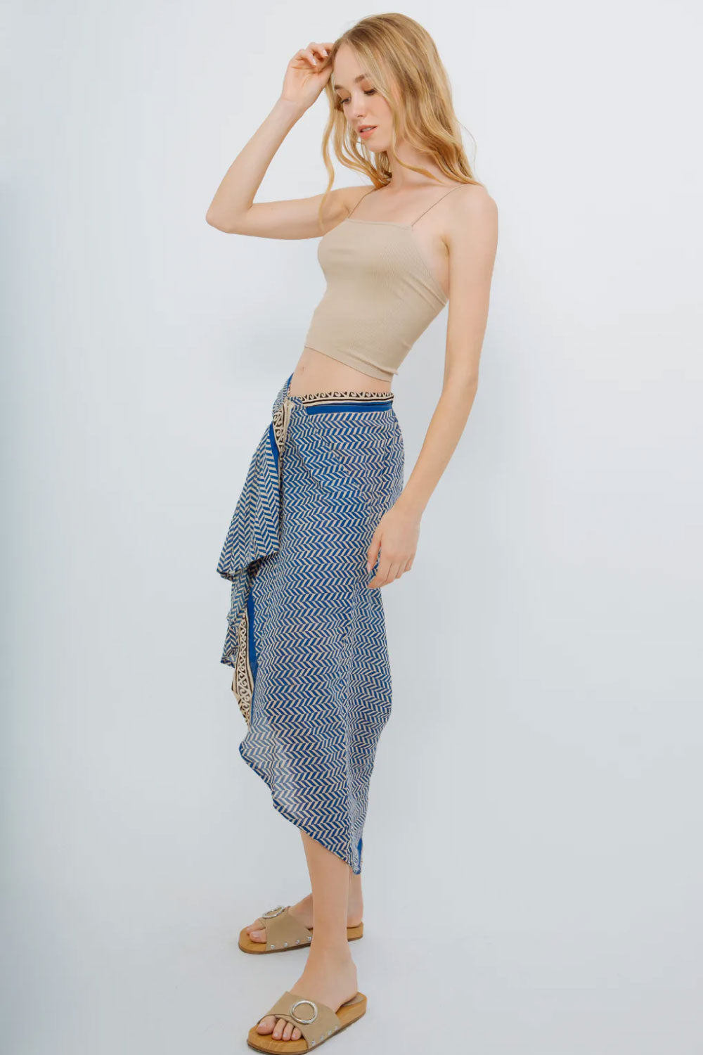 Image of the side of Guadalupe Design's Ashi Pareo Skirt in Blue on a model.