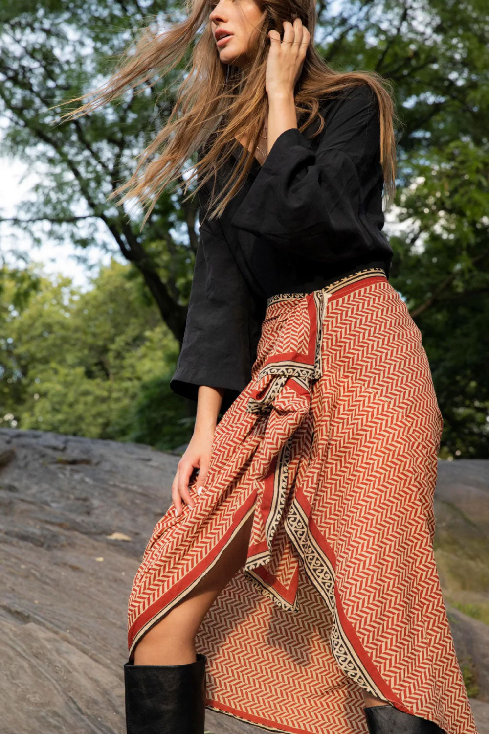 Image of the side of Guadalupe Design's Ashi Pareo Skirt in Red on a model.