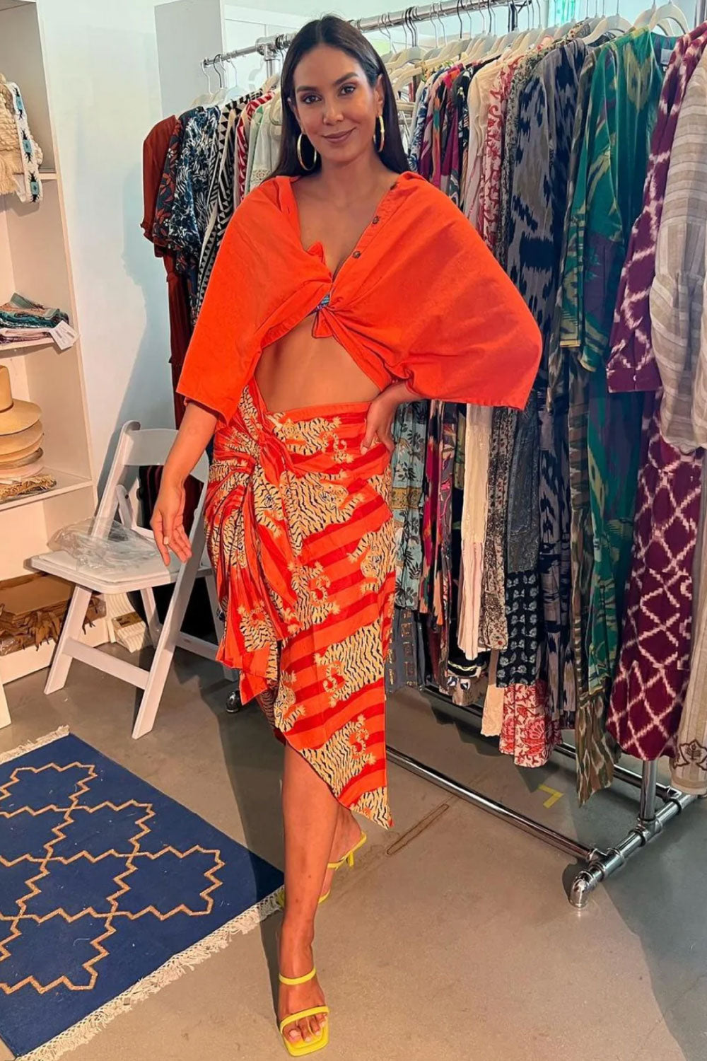 Image of the front of Guadalupe Design's Tiger Pareo Skirt in Orange on a model.