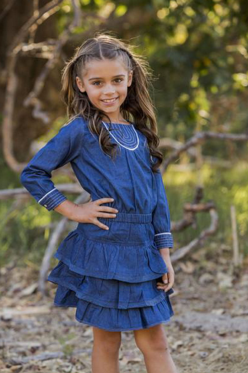 Image of a child wearing the Lacey Skirt in Denim.