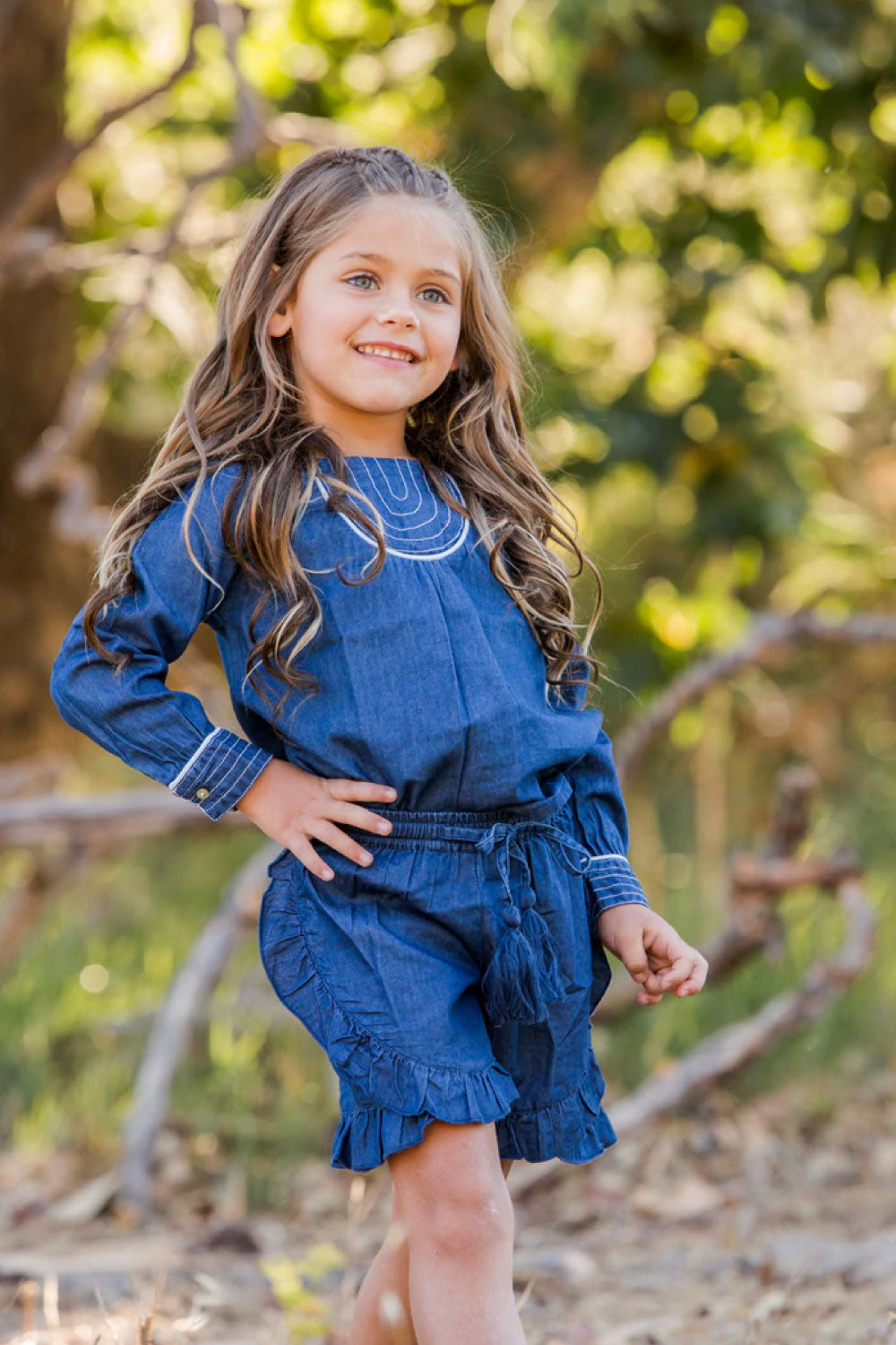 Image of a child wearing the Larissa Shorts in Denim.