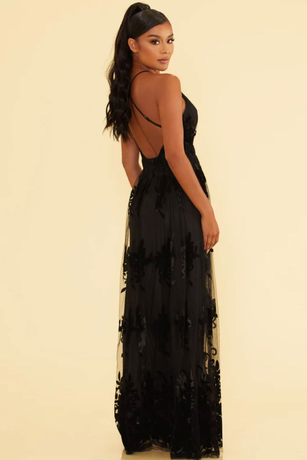 Image of the back of Luxxel's Elegant Lace Gown in Black on a model.