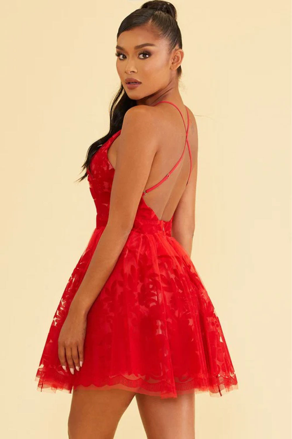 Image of the back of Luxxel's Elegant Lace Mini Dress in Red on a model.