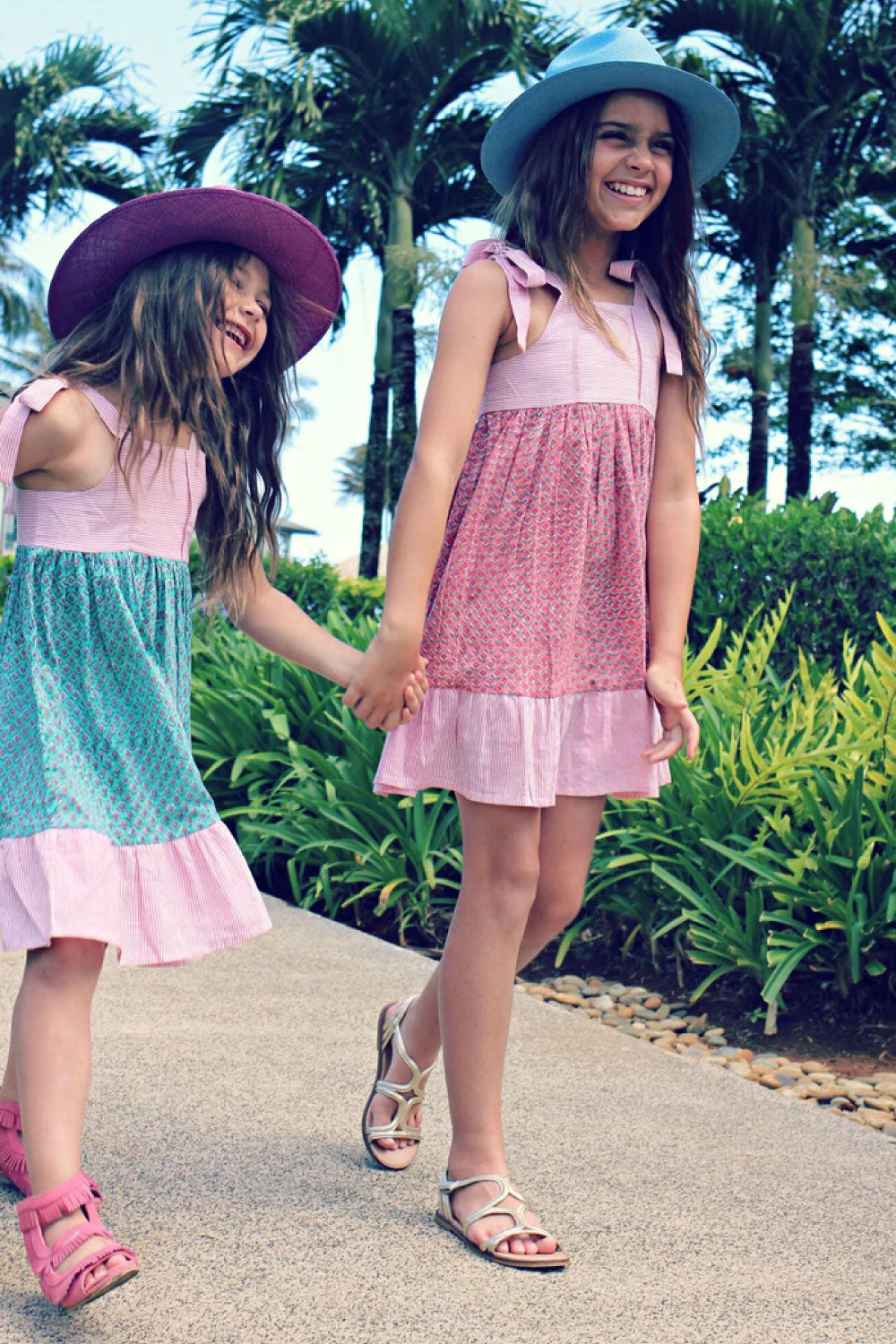 Image of a child wearing the Misha Dress in Pink.