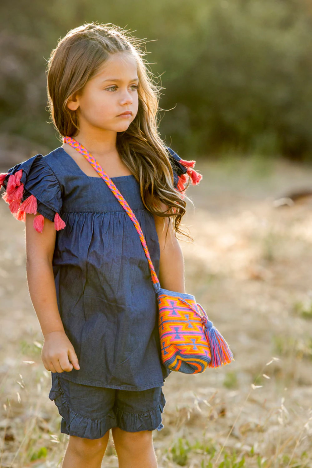Image of a child wearing the Seraphina Tassel Dress.